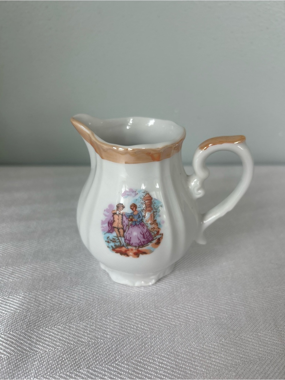 White Porcelain Creamer with Gold Trim and Vintage Romantic Scene
